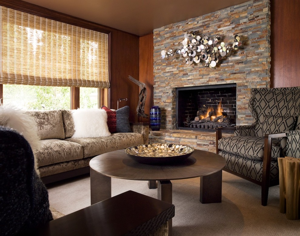 This is an example of a medium sized rustic living room in San Francisco with brown walls, carpet, a standard fireplace and a stone fireplace surround.