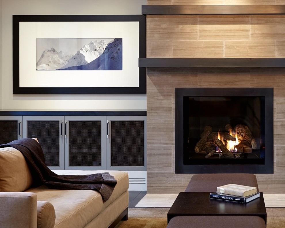 This is an example of a large contemporary open plan living room in San Francisco with white walls, dark hardwood flooring, a standard fireplace, a tiled fireplace surround and a concealed tv.