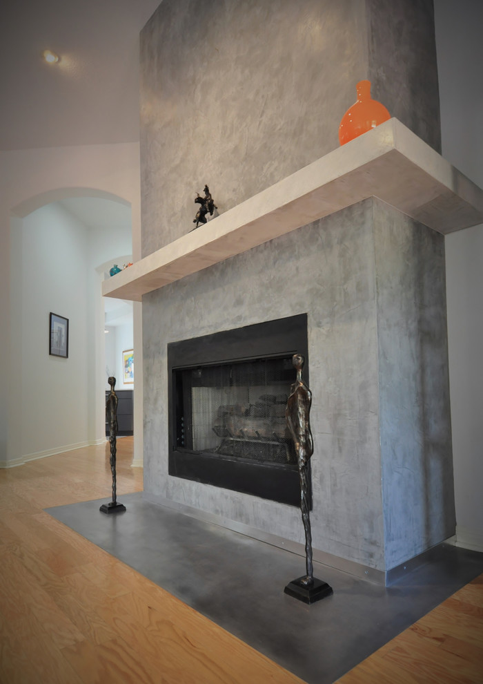 Inspiration for a contemporary living room remodel in Austin with a plaster fireplace
