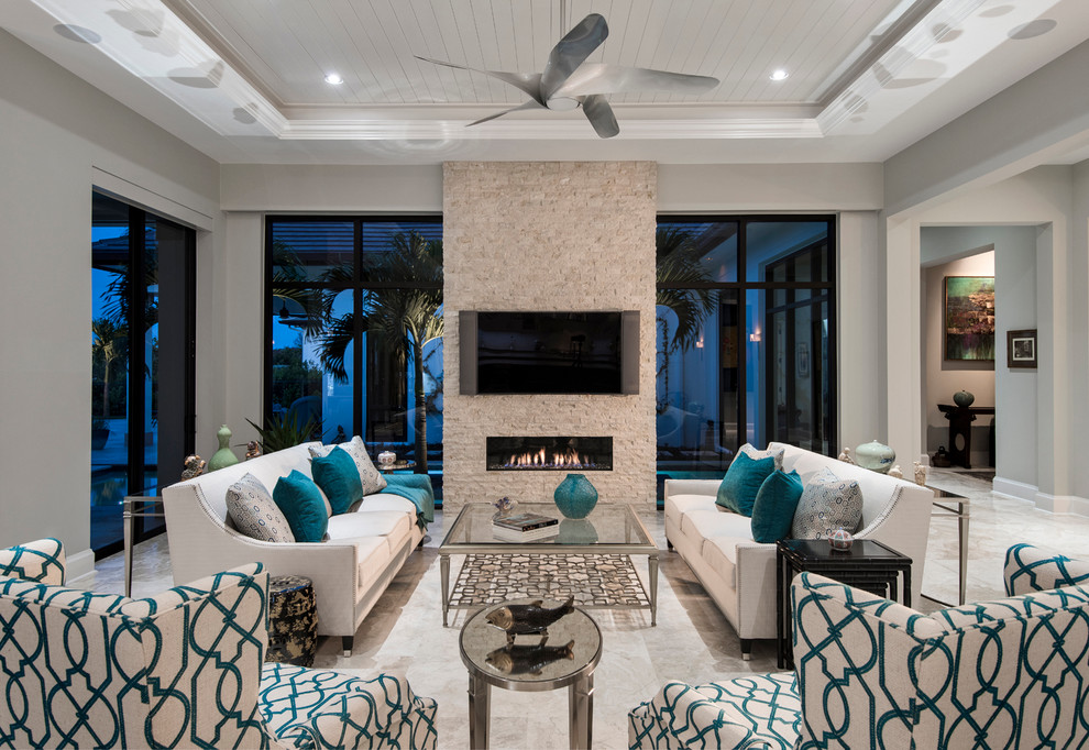 Living room - mid-sized transitional open concept travertine floor living room idea in Miami with gray walls, a ribbon fireplace, a stone fireplace and a wall-mounted tv