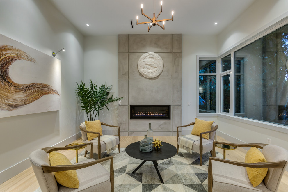 Example of a trendy formal and enclosed light wood floor and beige floor living room design in Vancouver with white walls, a ribbon fireplace, a concrete fireplace and no tv