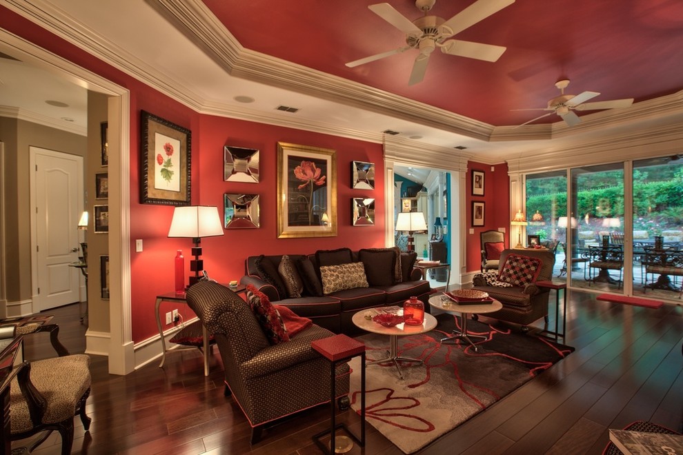 Large contemporary enclosed living room in Atlanta with red walls, dark hardwood flooring, a standard fireplace and a stone fireplace surround.
