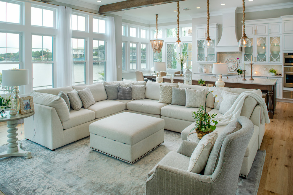 Living room - coastal open concept medium tone wood floor and brown floor living room idea in Tampa with gray walls