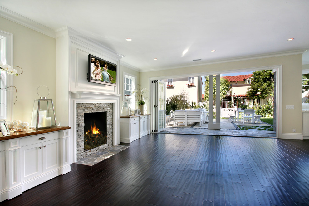 Inspiration for a coastal dark wood floor living room remodel in Orange County with a stone fireplace
