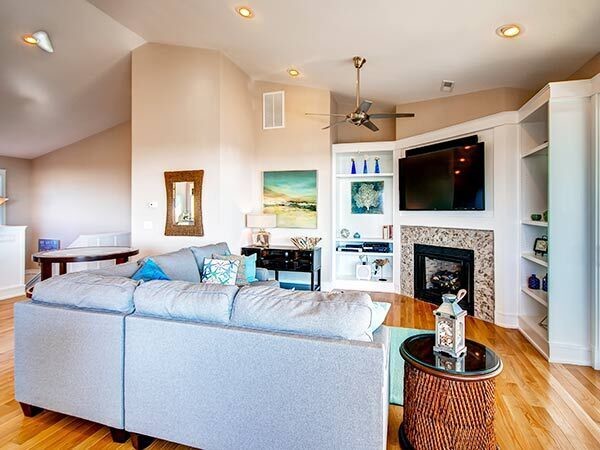 Inspiration for a medium sized coastal formal and grey and teal open plan living room in Other with beige walls, medium hardwood flooring, a corner fireplace, a tiled fireplace surround and a wall mounted tv.