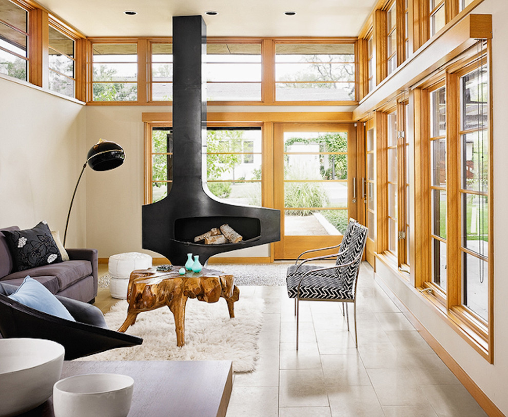 Living room - mid-sized scandinavian formal and open concept limestone floor and beige floor living room idea in Austin with a hanging fireplace, beige walls, a metal fireplace and no tv