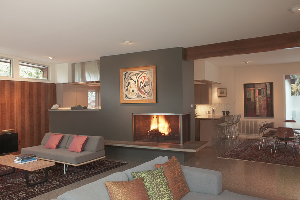 Photo of a large retro formal open plan living room in Austin with a standard fireplace, grey walls, concrete flooring, a metal fireplace surround and no tv.