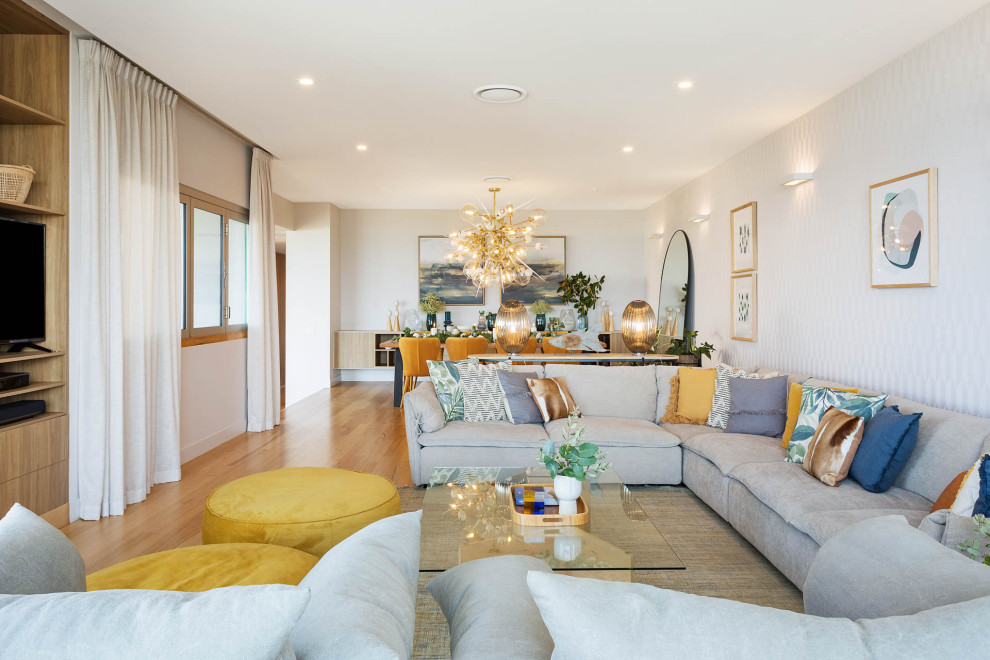 Large beach style light wood floor living room photo in Sydney with beige walls and a media wall
