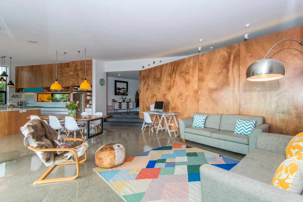 Foto di un soggiorno contemporaneo di medie dimensioni e aperto con pareti bianche e pavimento in cemento