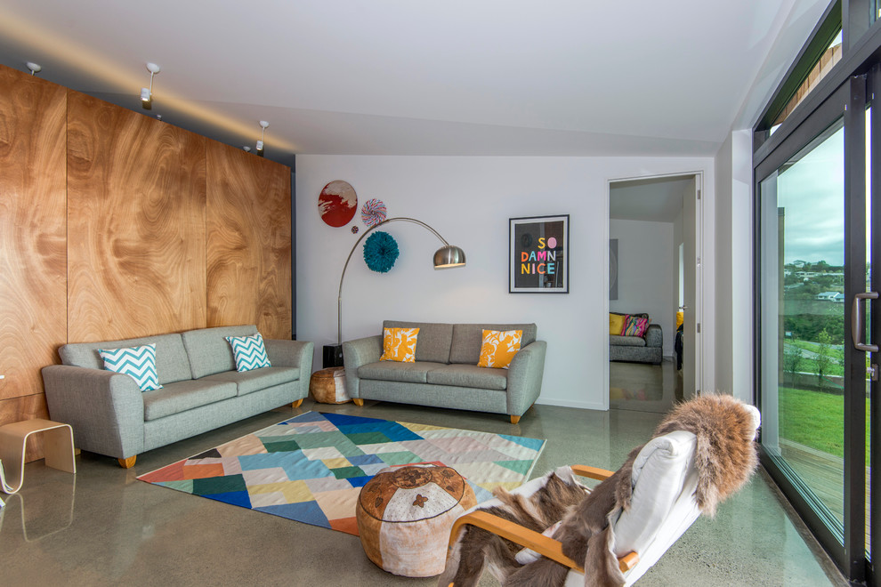 Mittelgroßes, Offenes Modernes Wohnzimmer mit weißer Wandfarbe und Betonboden in Christchurch