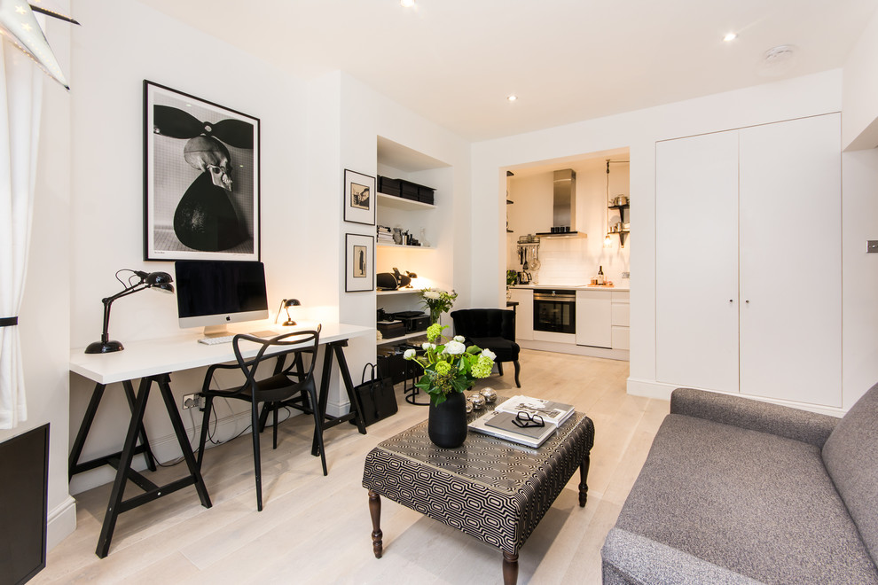 Medium sized scandi formal open plan living room in London with light hardwood flooring, white walls and beige floors.