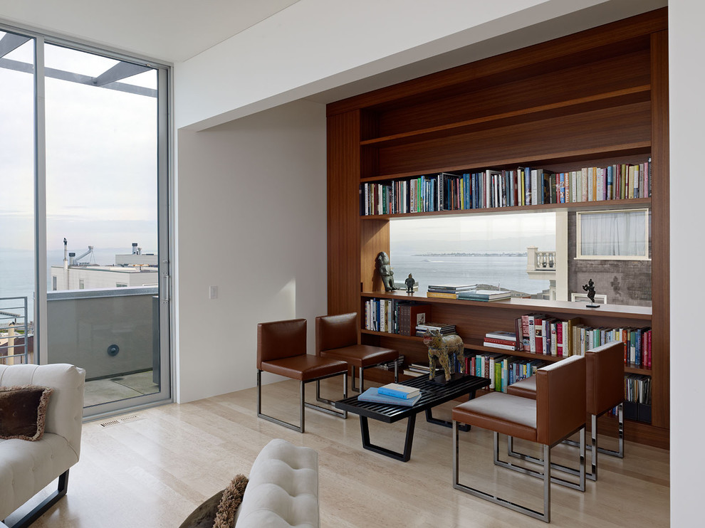 На фото: гостиная комната в стиле модернизм с с книжными шкафами и полками
