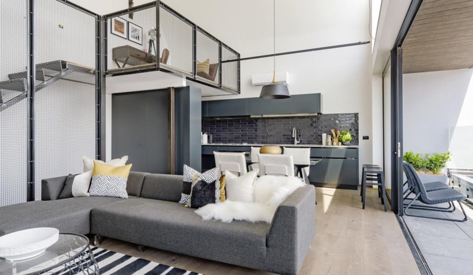 This is an example of an urban open plan living room in Auckland with white walls, light hardwood flooring, a wood burning stove, a metal fireplace surround, no tv and beige floors.
