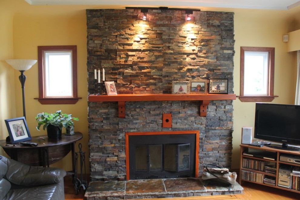 This is an example of a contemporary living room in Ottawa with a standard fireplace and a stone fireplace surround.