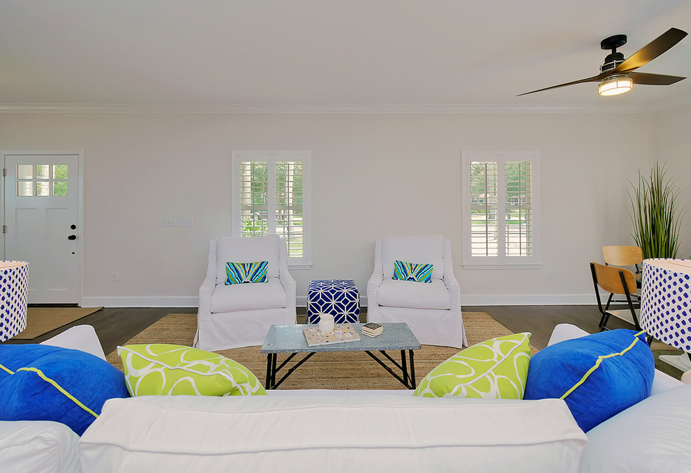Ispirazione per un soggiorno costiero di medie dimensioni con pareti bianche, pavimento in legno massello medio e pavimento marrone