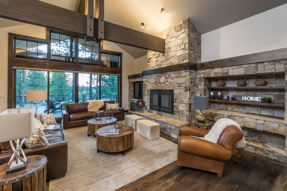 Photo of a large rustic formal open plan living room in Other with grey walls, medium hardwood flooring, a standard fireplace, a stone fireplace surround and a built-in media unit.