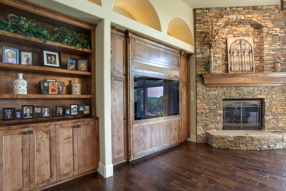 This is an example of an expansive classic open plan living room in Dallas with beige walls, dark hardwood flooring, a corner fireplace, a stone fireplace surround and a built-in media unit.
