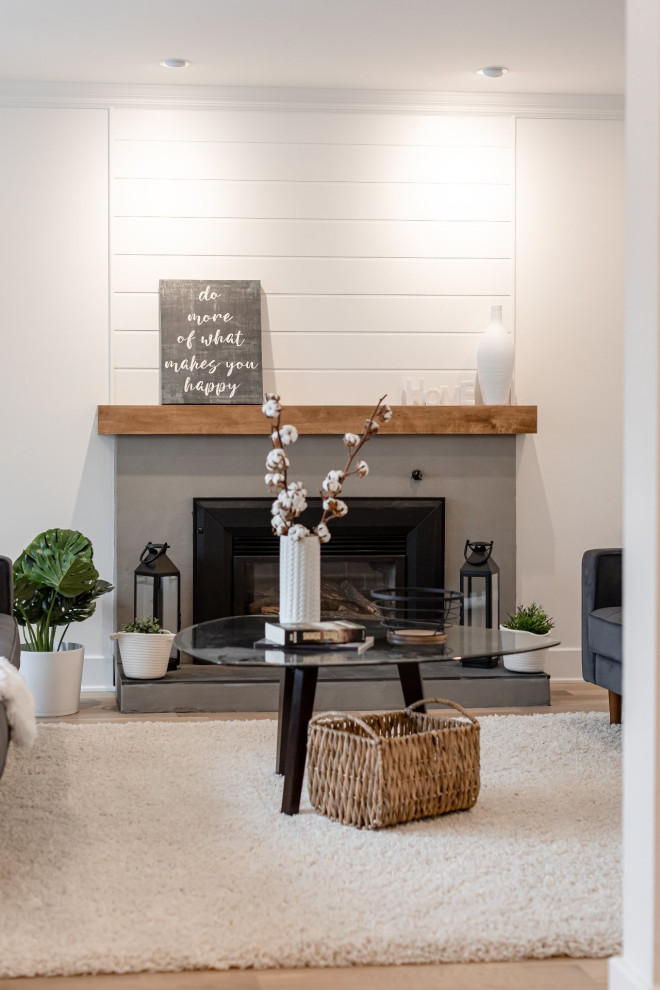 Mid-sized cottage formal and enclosed light wood floor and gray floor living room photo in Montreal with white walls, a standard fireplace and a brick fireplace