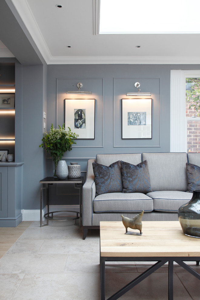 Large traditional formal enclosed living room in London with grey walls.