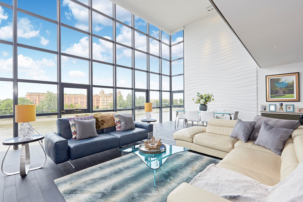 This is an example of a medium sized contemporary formal open plan living room in London with white walls and grey floors.