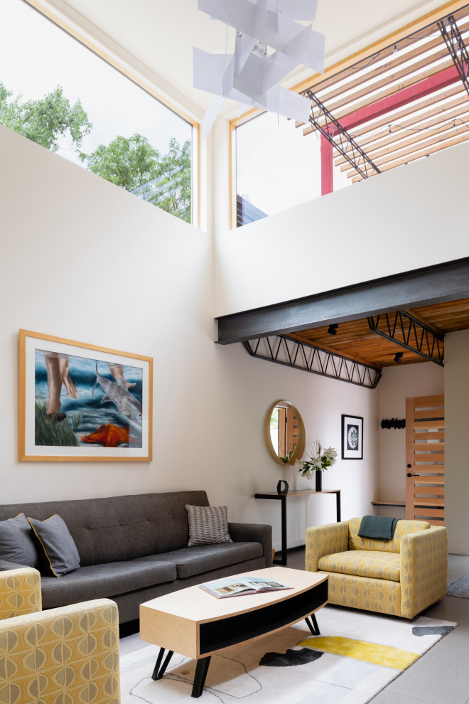 Medium sized industrial open plan living room in Denver with beige walls, porcelain flooring and grey floors.