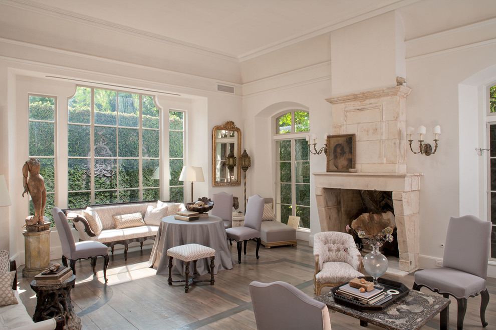 Inspiration for a french country formal and enclosed living room remodel in Houston with white walls, a standard fireplace, a stone fireplace and no tv