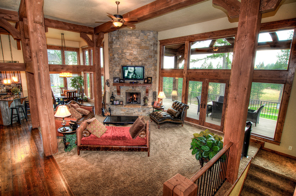 Inspiration for a large craftsman formal and open concept carpeted living room remodel in Seattle with beige walls, a corner fireplace, a stone fireplace and a wall-mounted tv