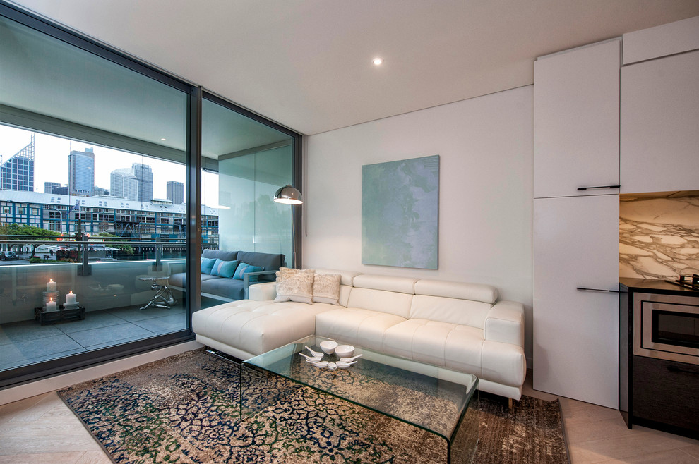 Medium sized contemporary open plan living room in Sydney with white walls, light hardwood flooring and no fireplace.
