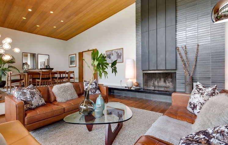 Inspiration for a large mid-century modern open concept and formal brown floor and medium tone wood floor living room remodel in San Francisco with white walls, a standard fireplace, a tile fireplace and no tv