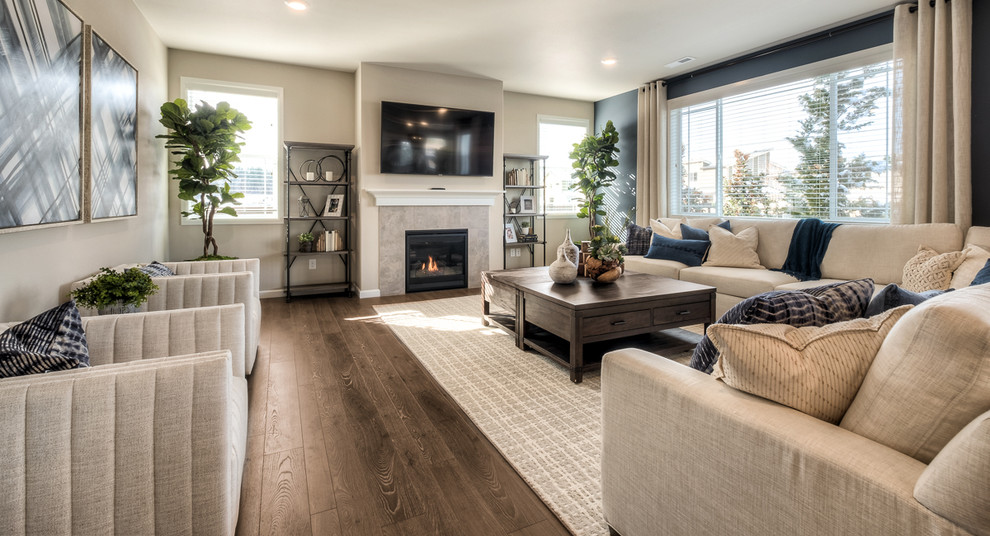 Inspiration for a large timeless formal and enclosed laminate floor and brown floor living room remodel in Seattle with beige walls, a standard fireplace, a tile fireplace and a wall-mounted tv