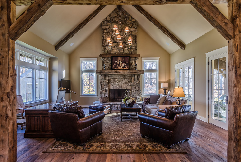 Mid-sized mountain style open concept and formal dark wood floor living room photo in New York with beige walls, a standard fireplace, a stone fireplace and a wall-mounted tv
