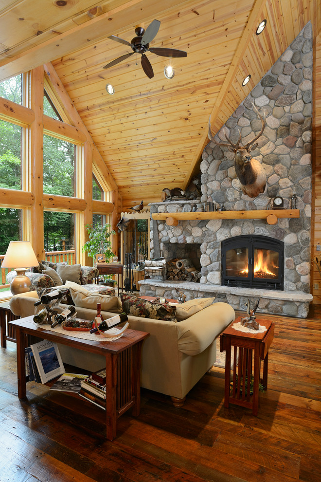 Inspiration for a rustic open plan living room in Other with dark hardwood flooring, a standard fireplace and a stone fireplace surround.