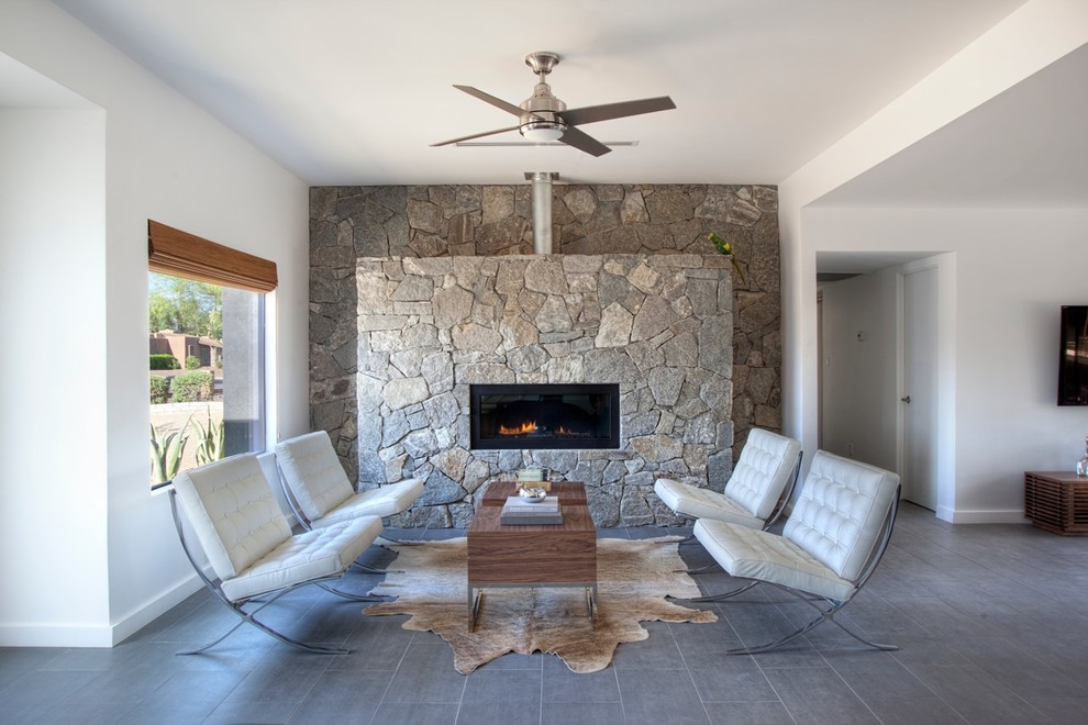 Inspiration for a modern living room in Phoenix with a ribbon fireplace and a stone fireplace surround.