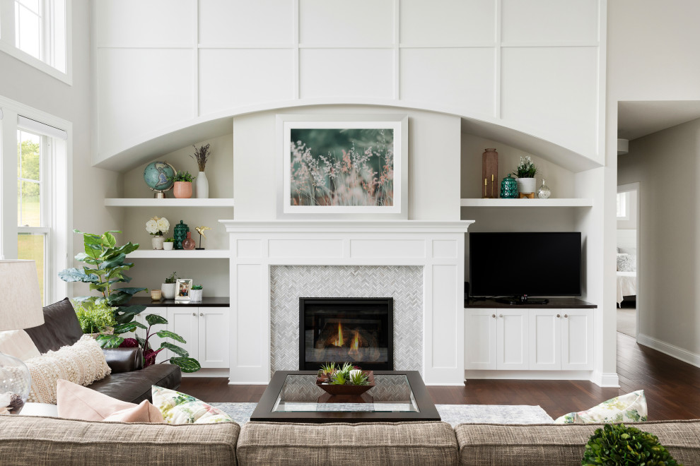 Design ideas for a medium sized classic open plan living room with grey walls, medium hardwood flooring, a standard fireplace, a tiled fireplace surround, a built-in media unit and brown floors.