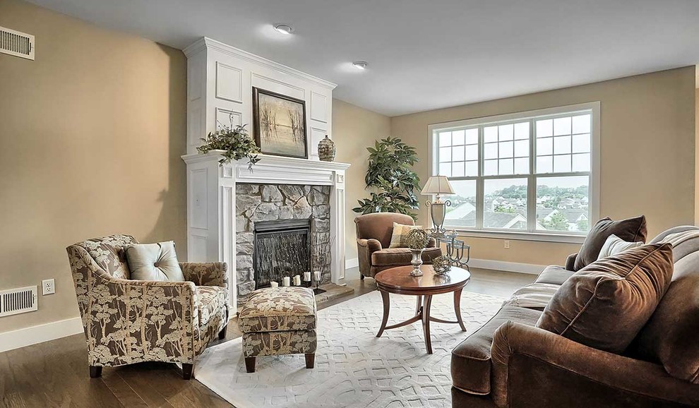 Large elegant open concept carpeted living room photo in Other with a standard fireplace and a stone fireplace