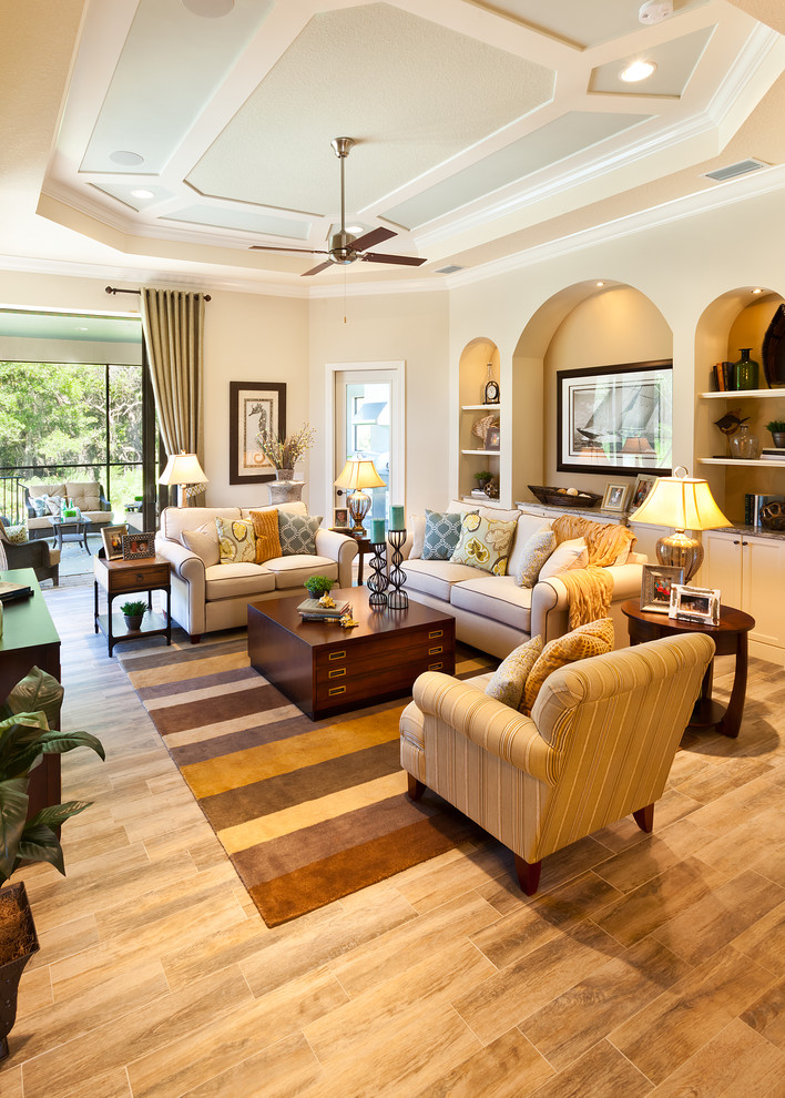 Inspiration for a large timeless open concept porcelain tile living room remodel in Tampa with beige walls, no fireplace and a wall-mounted tv