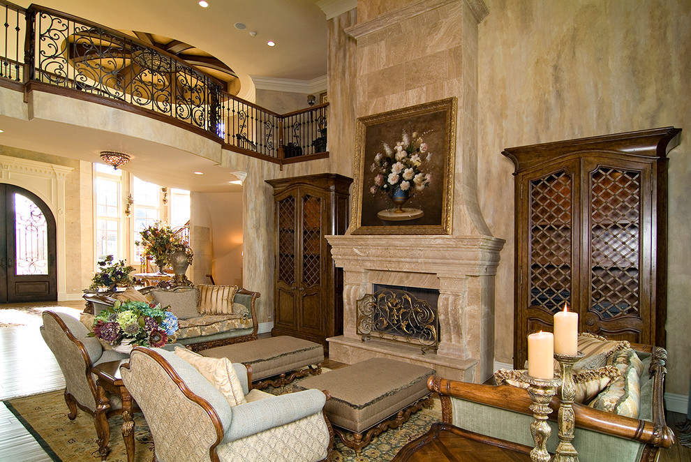 Photo of a large classic formal open plan living room in Chicago with beige walls, light hardwood flooring, a standard fireplace, a plastered fireplace surround, no tv and brown floors.