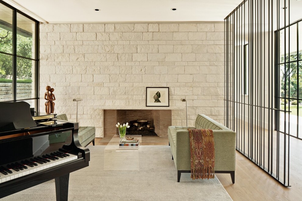 На фото: гостиная комната в стиле модернизм с музыкальной комнатой