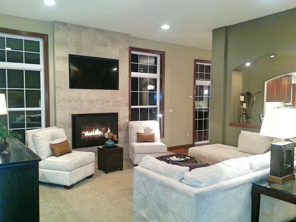 Photo of a medium sized classic enclosed living room in Other with green walls, carpet, a standard fireplace, a tiled fireplace surround and a built-in media unit.