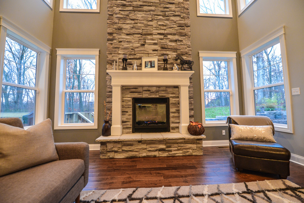 Inspiration for a large craftsman open concept dark wood floor living room remodel in Chicago with beige walls, a standard fireplace and a stone fireplace