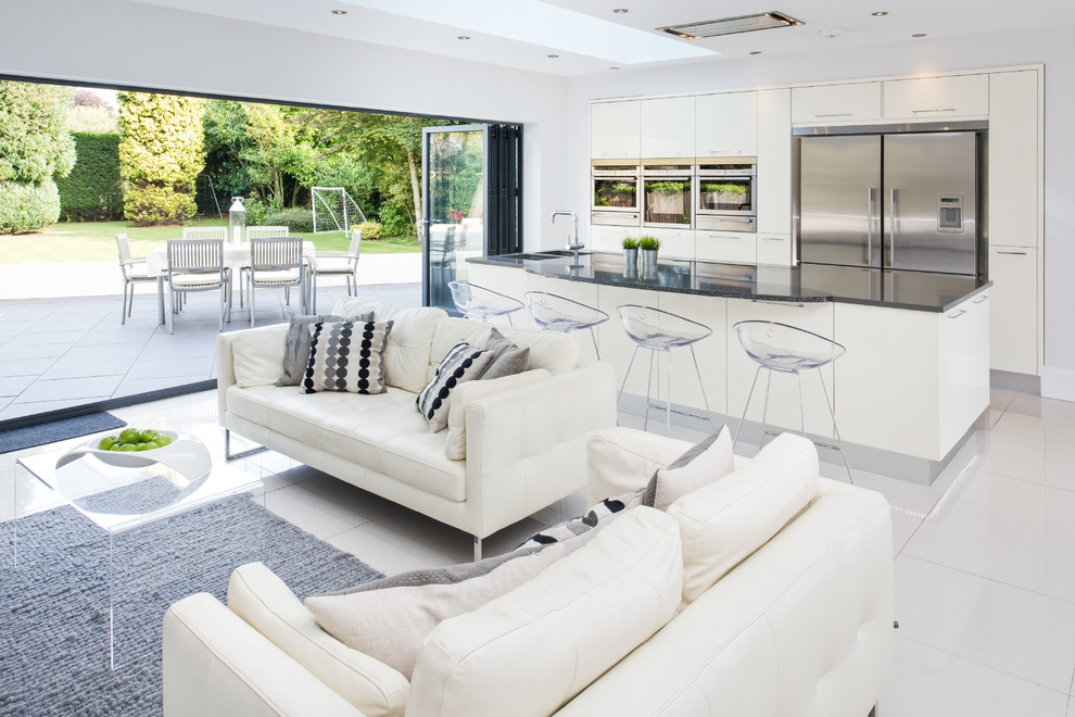 Trendy open concept living room photo in West Midlands with white walls
