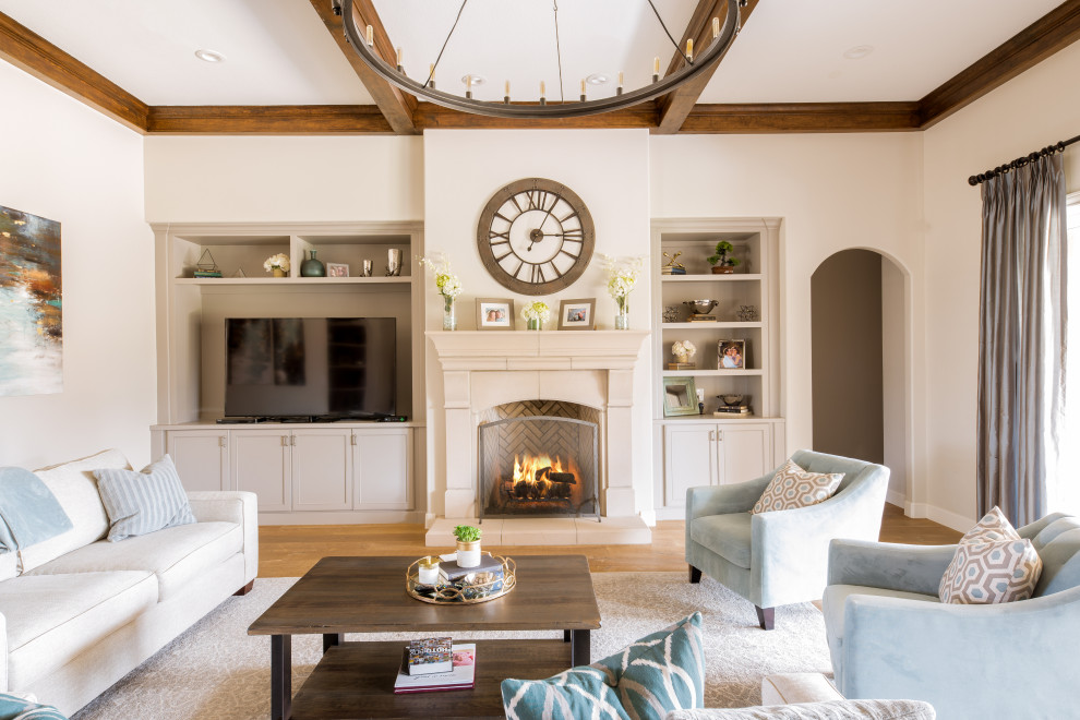 Example of a large transitional enclosed light wood floor and beige floor living room design in Austin with white walls, a standard fireplace and a media wall