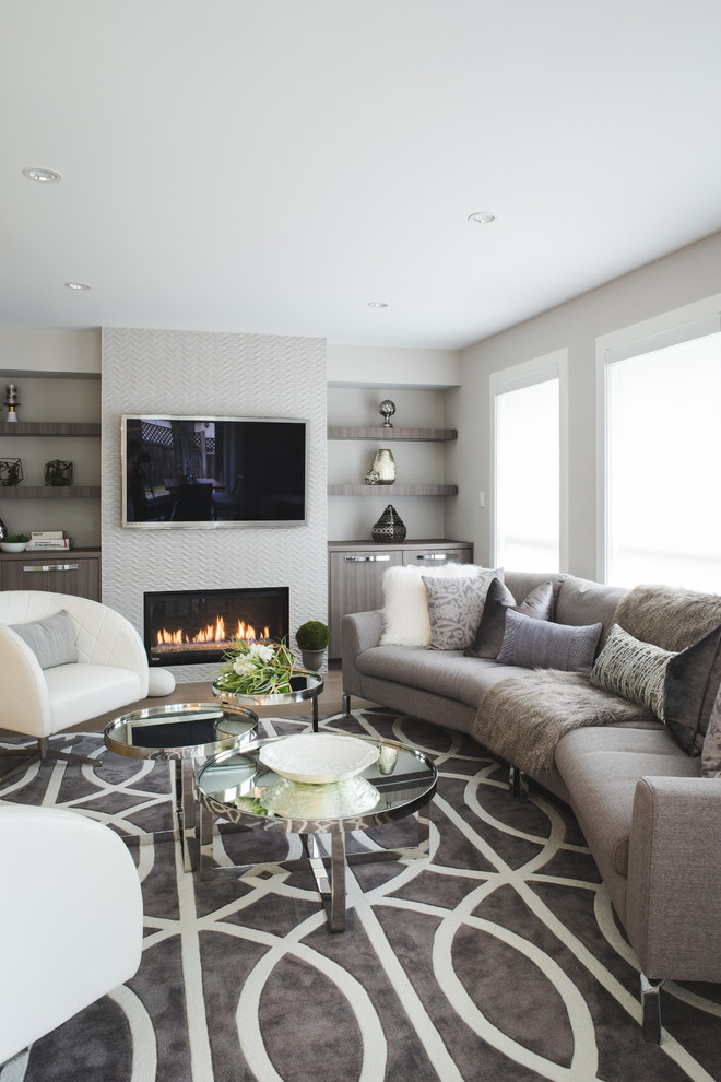 Inspiration for a large contemporary formal and open concept dark wood floor and brown floor living room remodel in Vancouver with gray walls, a standard fireplace, a tile fireplace and a wall-mounted tv