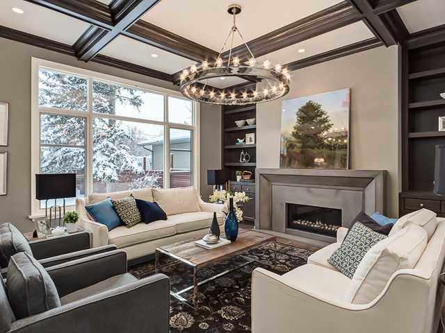 This is an example of a traditional living room in Calgary with a concrete fireplace surround.
