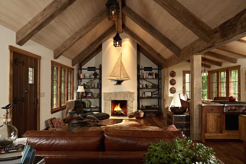 Photo of a rustic living room in Minneapolis with dark hardwood flooring and a standard fireplace.