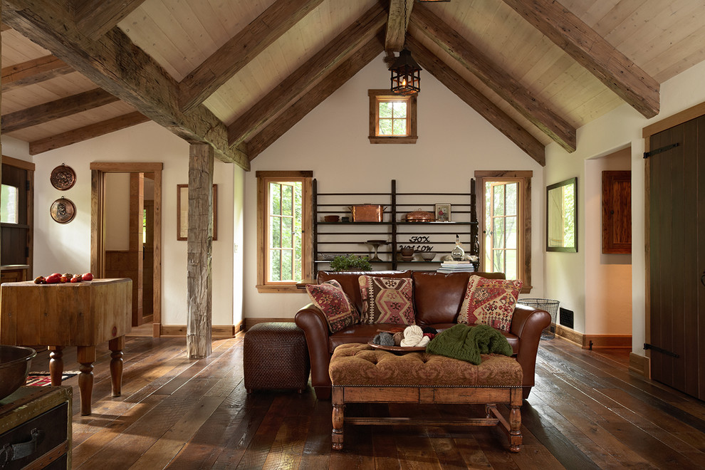 This is an example of a rustic living room in Minneapolis with white walls and dark hardwood flooring.