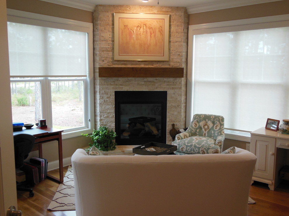 Example of a mid-sized classic formal and enclosed medium tone wood floor and brown floor living room design in Wilmington with brown walls, a corner fireplace, a stone fireplace and no tv