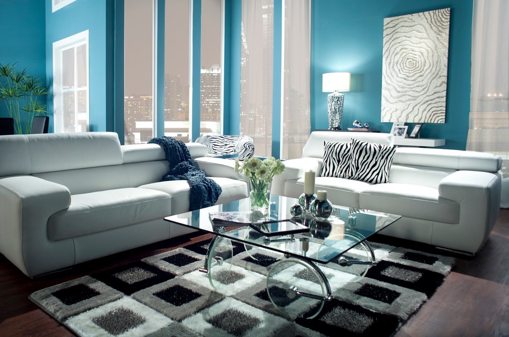 Esempio di un piccolo soggiorno contemporaneo chiuso con pareti blu e parquet scuro