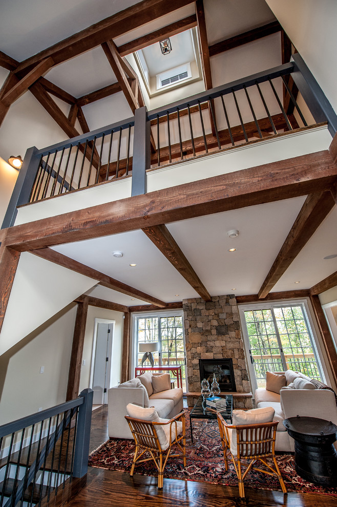 Photo of a large rural open plan living room in Boston with beige walls, dark hardwood flooring, a standard fireplace and a stone fireplace surround.