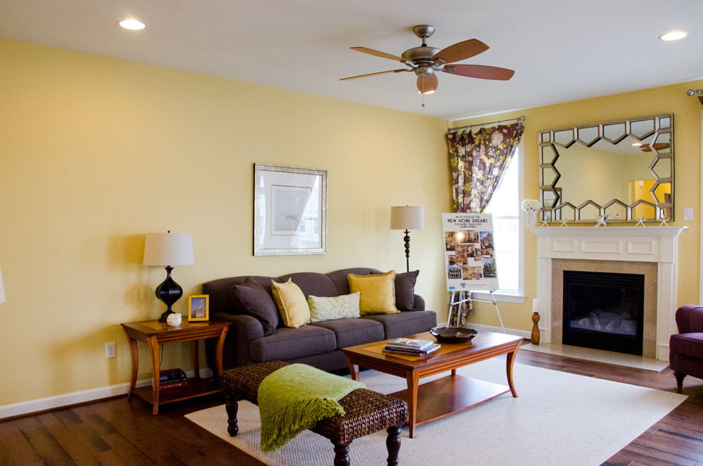 Photo of a beach style living room in Other with yellow walls, dark hardwood flooring and a standard fireplace.
